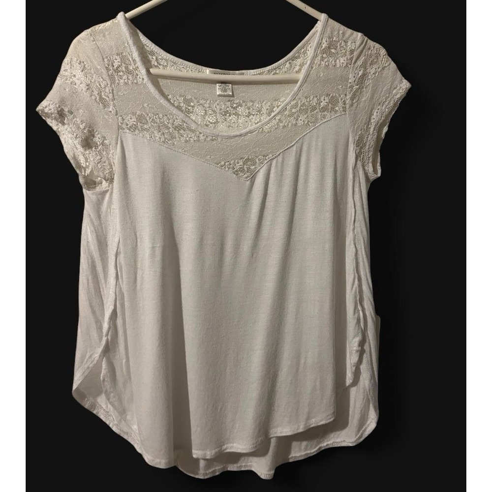 Romantic white lacy blouse with angled hem lines